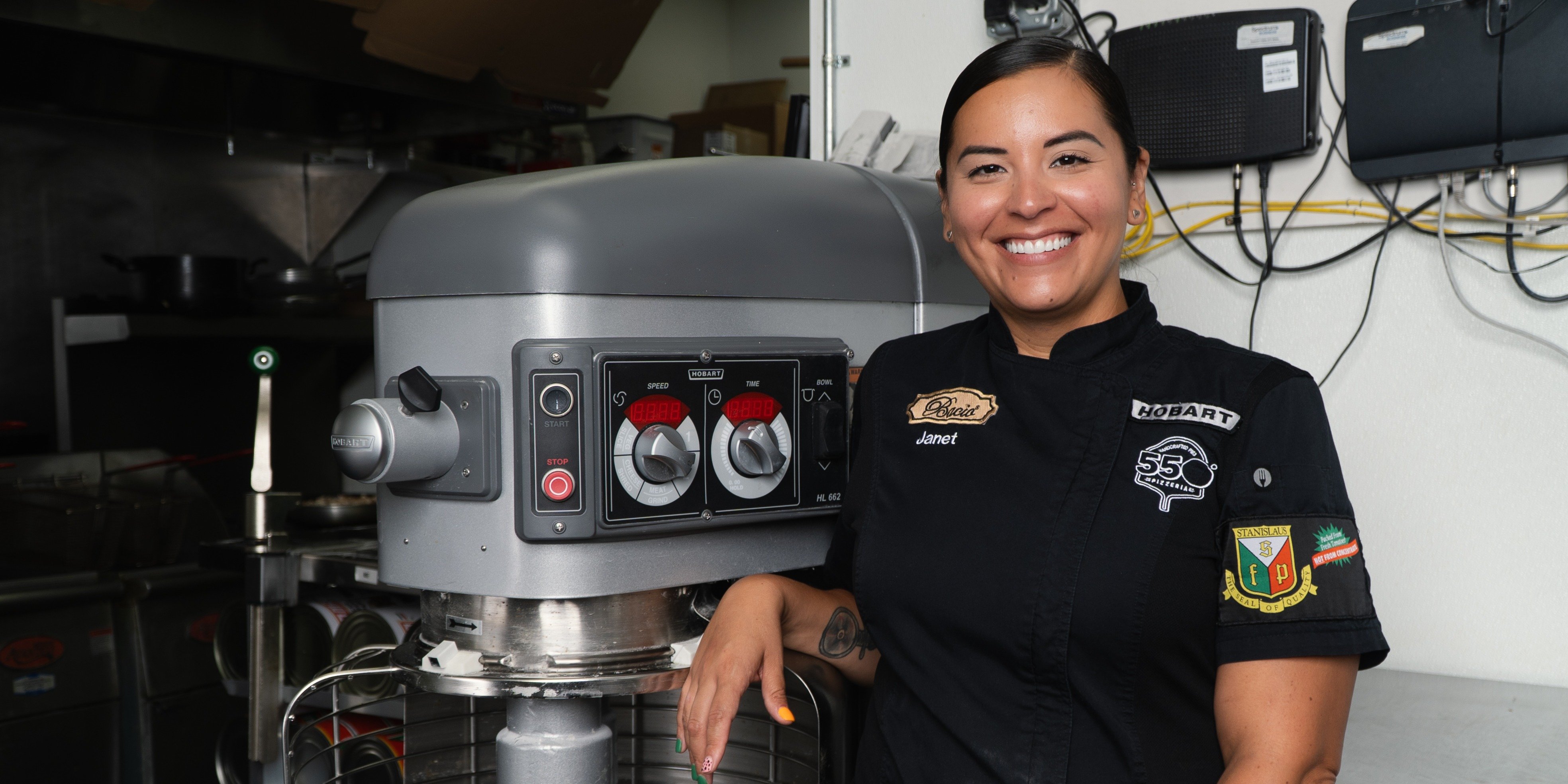 Janet Zapata poses with her Hobart HL662 commercial pizza dough mixer